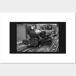 Engineer tending to a steam train Posters and Art